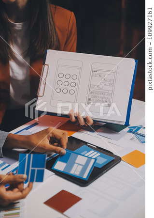 team of UI UX web designer are working together to develop mobile responsive websites. Mobile Mockup 109927161