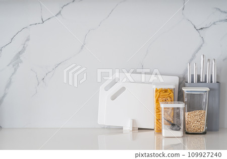 Kitchen utensils on white table Kitchen utensils on white table 109927240