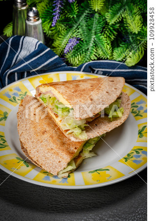 Tortilla multigrain with omelette, lettuce and ham. Tortilla multigrain with omelette, lettuce and ham. 109928458