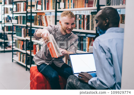 Smiling student sharing data with classmate Smiling student sharing data with classmate 109929774