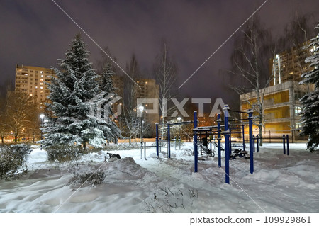 Winter cityscape with and snow-covered fir trees and sports equipment in Moscow, Russia Winter cityscape with and snow-covered fir trees and sports equipment in Moscow, Russia 109929861