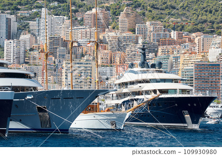 Few huge luxury yachts at the famous motorboat exhibition in the principality of Monaco, Monte Carlo, the most expensive boats for the richest people, mountain and residential complex on background Few huge luxury yachts at the famous motorboat exhibition in the principality of Monaco, Monte Carlo, the most expensive boats for the richest people, mountain and residential complex on background 109930980