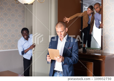 Young man solving puzzles in quest room 109932730