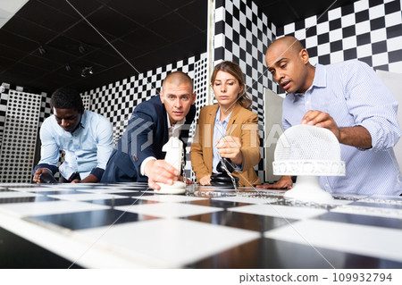 People trying together to find solution of conundrum in quest room People trying together to find solution of conundrum in quest room 109932794