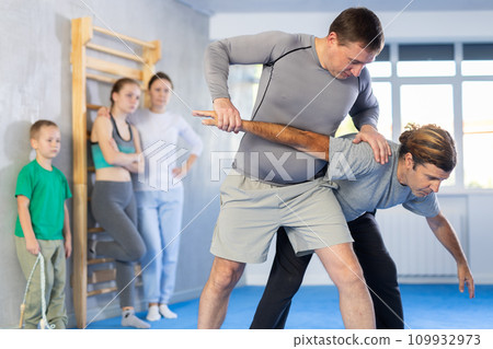 Man in gym perform basic elements of krav maga self-defense system. 109932973