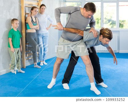 Man in gym perform basic elements of krav maga self-defense system. Man in gym perform basic elements of krav maga self-defense system. 109933252
