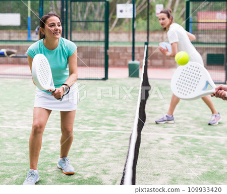 Two sports couples playing padel on tennis court 109933420