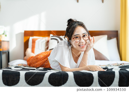 Young woman relaxing in bedroom 109934330