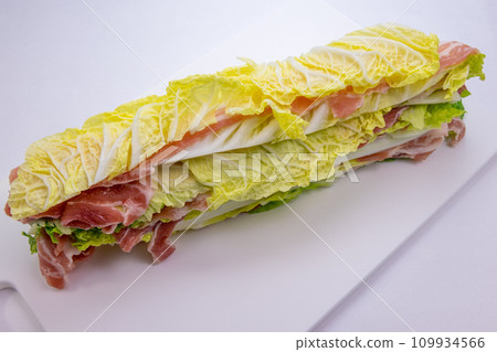 Preparing a hot pot with pork and cabbage Preparing a hot pot with pork and cabbage 109934566
