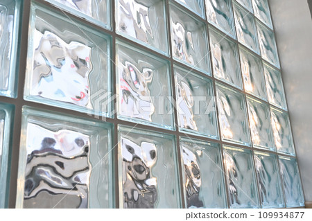 close up glass block wall with golden natural light background, interior design 109934877