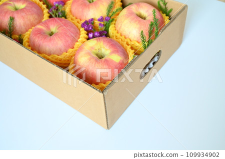 beautiful pink apple in the box on light blue background 109934902