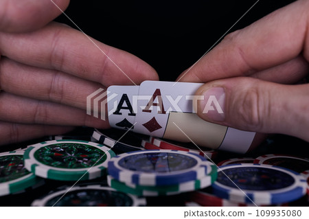 Dealer or croupier shuffles poker cards in a casino on the background of a table, chips. Concept of poker game. Playing for money, a big win, jackpot. 109935080