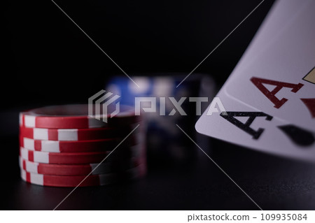 Dealer or croupier shuffles poker cards in a casino on the background of a table, chips. Concept of poker game. Playing for money, a big win, jackpot. Dealer or croupier shuffles poker cards in a casino on the background of a table, chips. Concept of poker game. Playing for money, a big win, jackpot. 109935084
