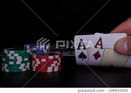 Dealer or croupier shuffles poker cards in a casino on the background of a table, chips. Concept of poker game. Playing for money, a big win, jackpot. 109935093