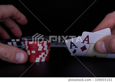 Dealer or croupier shuffles poker cards in a casino on the background of a table, chips. Concept of poker game. Playing for money, a big win, jackpot. Dealer or croupier shuffles poker cards in a casino on the background of a table, chips. Concept of poker game. Playing for money, a big win, jackpot. 109935101