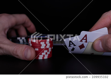 Dealer or croupier shuffles poker cards in a casino on the background of a table, chips. Concept of poker game. Playing for money, a big win, jackpot. Dealer or croupier shuffles poker cards in a casino on the background of a table, chips. Concept of poker game. Playing for money, a big win, jackpot. 109935102