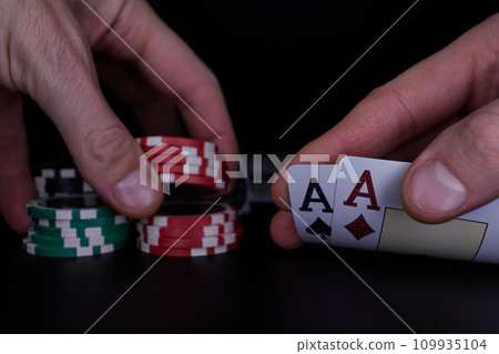Dealer or croupier shuffles poker cards in a casino on the background of a table, chips. Concept of poker game. Playing for money, a big win, jackpot. 109935104