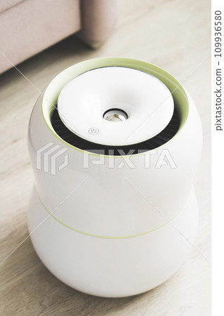 air purifier and air humidifier in the room, dry air humidification and water purification of indoor air, selective focusing, tinted image, sun glare 109936580