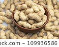 peanuts in a shell in a clay plate, organic peanuts isolated on a white background top view. A bunch of peanuts in close-up, selective focus. 109936586