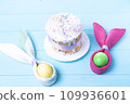 Easter cake and colorful Easter eggs close-up top view, selective focus, tinted image 109936601