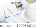 white helmet and tape measure, pencil ruler and construction drawings, selective focus, tinted image, construction concept repair and reconstruction of buildings and structures 109936611