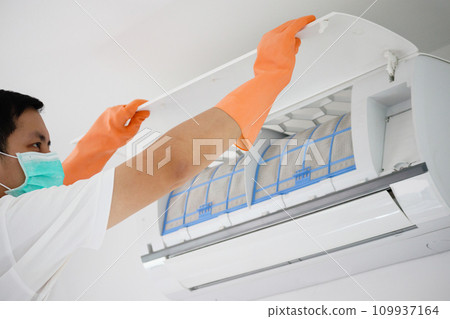 Asian man cleaning air conditioner dirty filter 109937164
