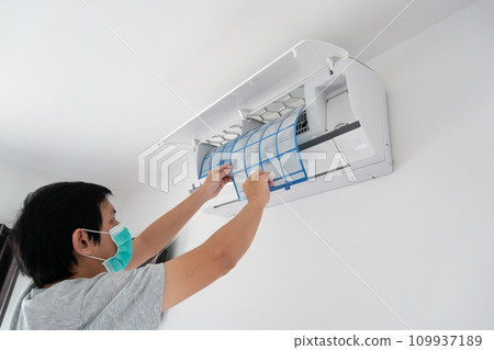 man hand hold air conditioner filter cleaning concept 109937189