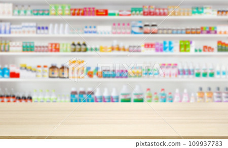 Empty wood counter top with pharmacy drugstore shelves blur pharmaceutical medicine product background 109937783