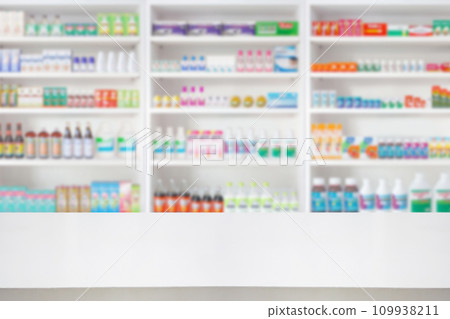 Empty wood counter top with pharmacy drugstore shelves blur pharmaceutical medicine product background 109938211