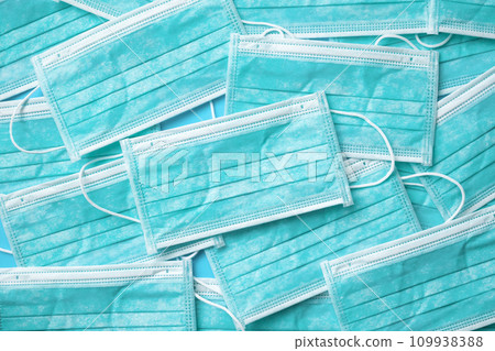 Blue surgical face mask texture background protection against air pollution and COVID-19 coronavirus. Healthcare and medical concept Blue surgical face mask texture background protection against air pollution and COVID-19 coronavirus. Healthcare and medical concept 109938388