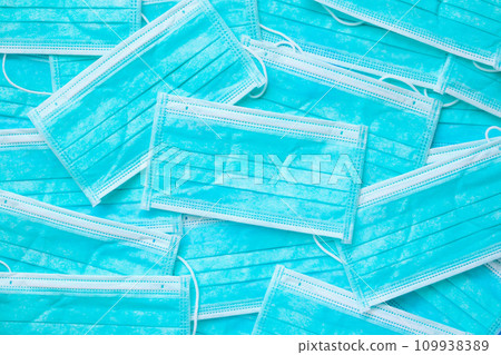 Blue surgical face mask texture background protection against air pollution and COVID-19 coronavirus. Healthcare and medical concept Blue surgical face mask texture background protection against air pollution and COVID-19 coronavirus. Healthcare and medical concept 109938389