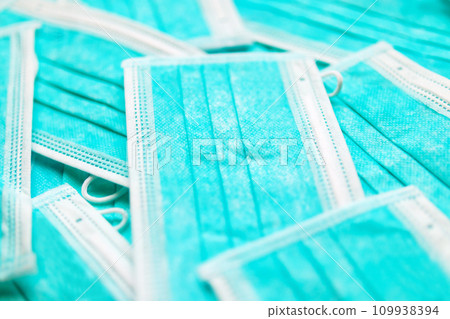 Blue surgical face mask texture background protection against air pollution and COVID-19 coronavirus. Healthcare and medical concept Blue surgical face mask texture background protection against air pollution and COVID-19 coronavirus. Healthcare and medical concept 109938394