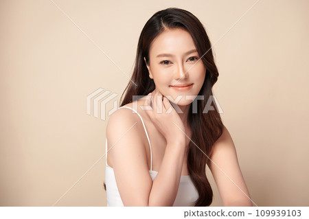 Beautiful young asian woman with clean fresh skin on beige background, Face care, Facial treatment, Cosmetology, beauty and spa, Asian women portrait. Beautiful young asian woman with clean fresh skin on beige background, Face care, Facial treatment, Cosmetology, beauty and spa, Asian women portrait. 109939103