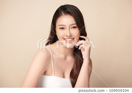 Beautiful young asian woman with clean fresh skin on beige background, Face care, Facial treatment, Cosmetology, beauty and spa, Asian women portrait. Beautiful young asian woman with clean fresh skin on beige background, Face care, Facial treatment, Cosmetology, beauty and spa, Asian women portrait. 109939104