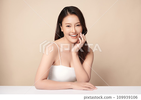 Beautiful young asian woman with clean fresh skin on beige background, Face care, Facial treatment, Cosmetology, beauty and spa, Asian women portrait. Beautiful young asian woman with clean fresh skin on beige background, Face care, Facial treatment, Cosmetology, beauty and spa, Asian women portrait. 109939106