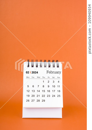 Vertical of Feburary 2024 table calendar on orange background. 109940934