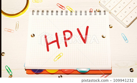 HPV word on a checkered notebook on a light table next to a magnifying glass, paper clips, stationery buttons, a calculator 109941232