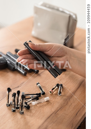 Women's hands hold cosmetics in close-up Women's hands hold cosmetics in close-up 109944459