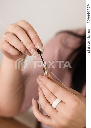 Holding a small perfume sample in your hands 109944579