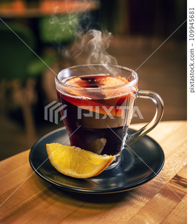 Mulled wine with orange in glasses. Mulled wine with orange in glasses. 109945681