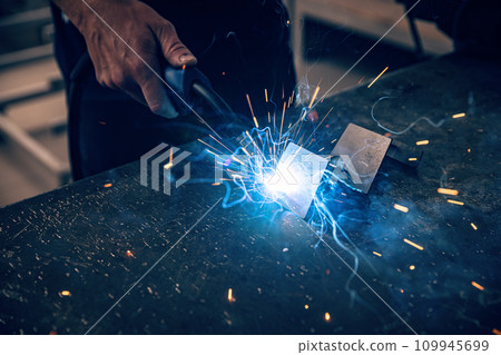 Male worker hand welding steel rack Male worker hand welding steel rack 109945699