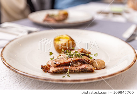 Beef steak with baked potato Beef steak with baked potato 109945700