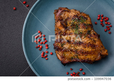 Delicious juicy beef or chicken steak with salt, spices and herbs Delicious juicy beef or chicken steak with salt, spices and herbs 109947036