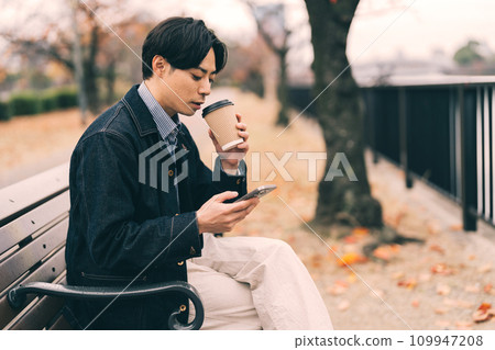man drinking coffee by the river man drinking coffee by the river 109947208