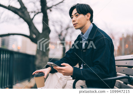 man drinking coffee by the river man drinking coffee by the river 109947215