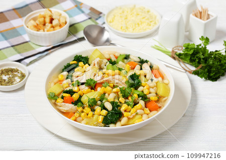 Chicken and white bean soup with veggies, corn 109947216