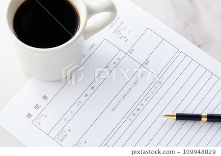 Writing a resume while drinking coffee Writing a resume while drinking coffee 109948029