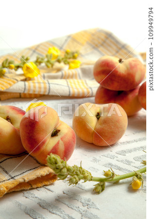 Several whole saturn peaches or flat peach on white wooden background.. Several whole saturn peaches or flat peach on white wooden background.. 109949794