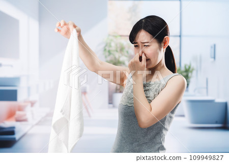woman smelling laundry woman smelling laundry 109949827