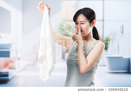 woman smelling laundry woman smelling laundry 109949828